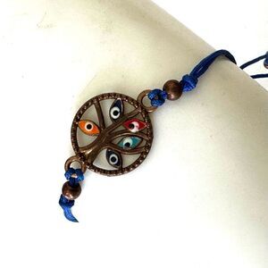 Evil eye tree charm bracelet on blue cord